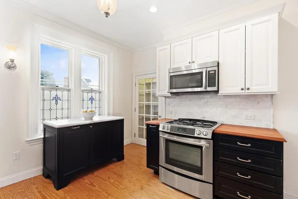 a kitchen with stainless steel appliances granite countertop a stove microwave and oven