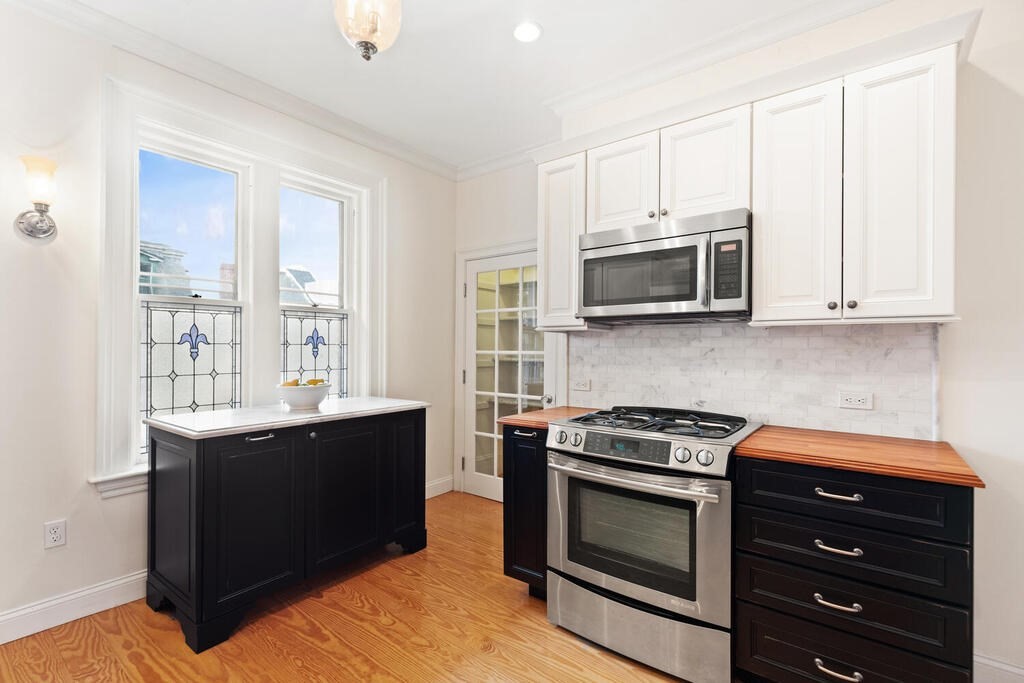 2 Rangeley Road, Unit 2 Winchester, MA 01890 - Photo 15 of 29 a kitchen with stainless steel appliances granite countertop a stove microwave and oven