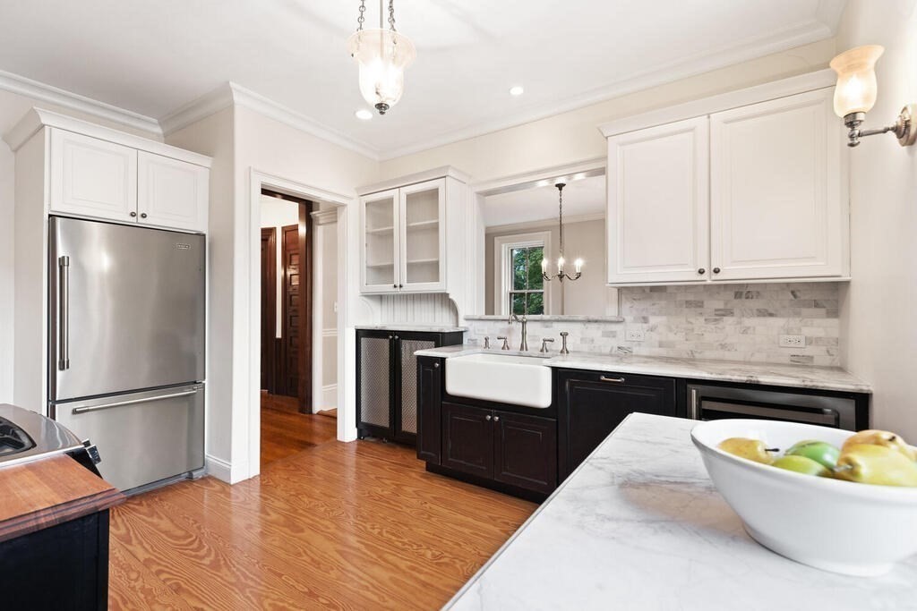 2 Rangeley Road, Unit 2 Winchester, MA 01890 - Photo 2 of 29 a kitchen with stainless steel appliances granite countertop a refrigerator a sink dishwasher a stove and white cabinets with wooden floor