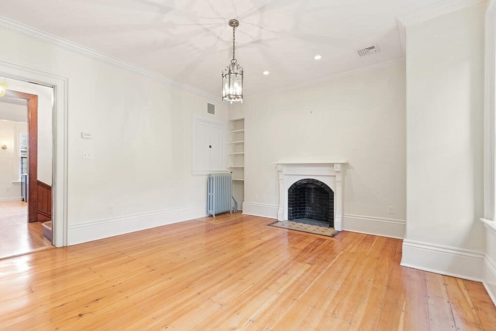 2 Rangeley Road, Unit 2 Winchester, MA 01890 - Photo 3 of 29 a view of empty room with wooden floor and fireplace