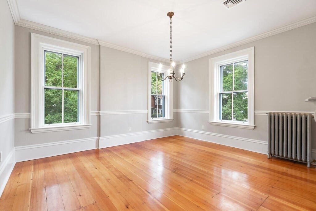 2 Rangeley Road, Unit 2 Winchester, MA 01890 - Photo 8 of 29 a view of an empty room with wooden floor and a window