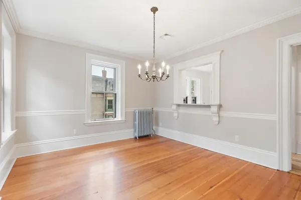 a view of a room with window and wooden floor