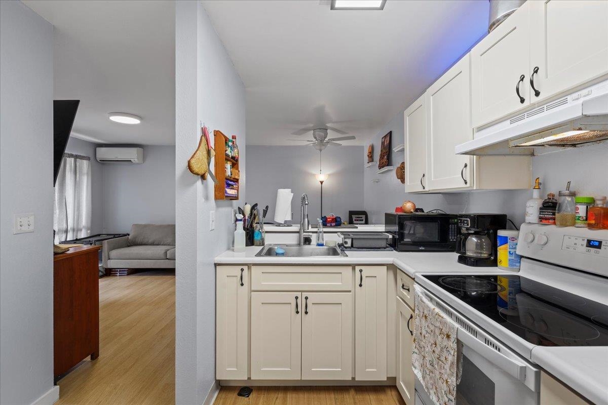 480 Kenolio Road, Unit 1103 Kihei, HI 96753 - Photo 13 of 32 a kitchen with a sink cabinets and appliances