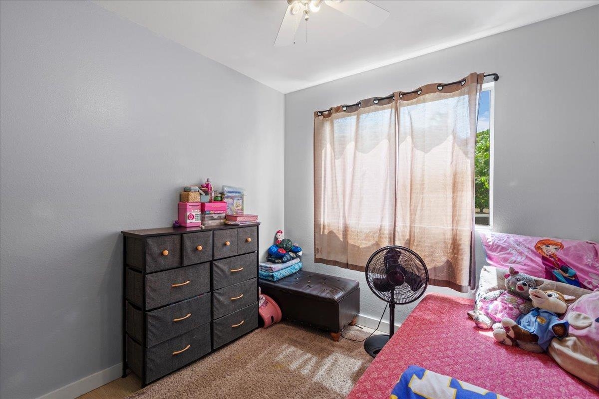 480 Kenolio Road, Unit 1103 Kihei, HI 96753 - Photo 19 of 32 a bedroom with furniture and a window
