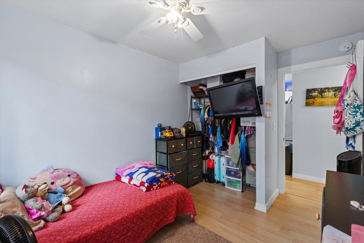 480 Kenolio Road, Unit 1103 Kihei, HI 96753 - Photo 20 of 32 a bedroom with bed and a flat tv screen on a dresser