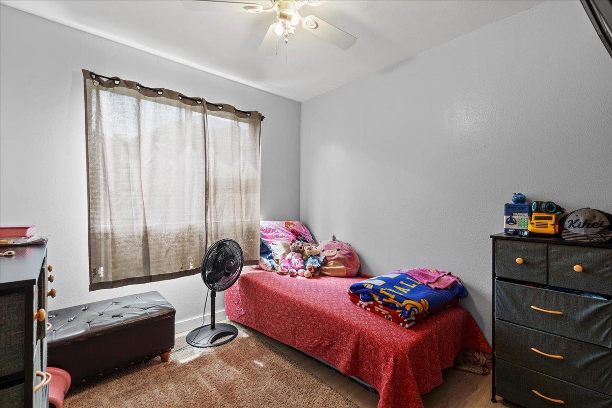 480 Kenolio Road, Unit 1103 Kihei, HI 96753 - Photo 21 of 32 a bedroom with a bed and a window