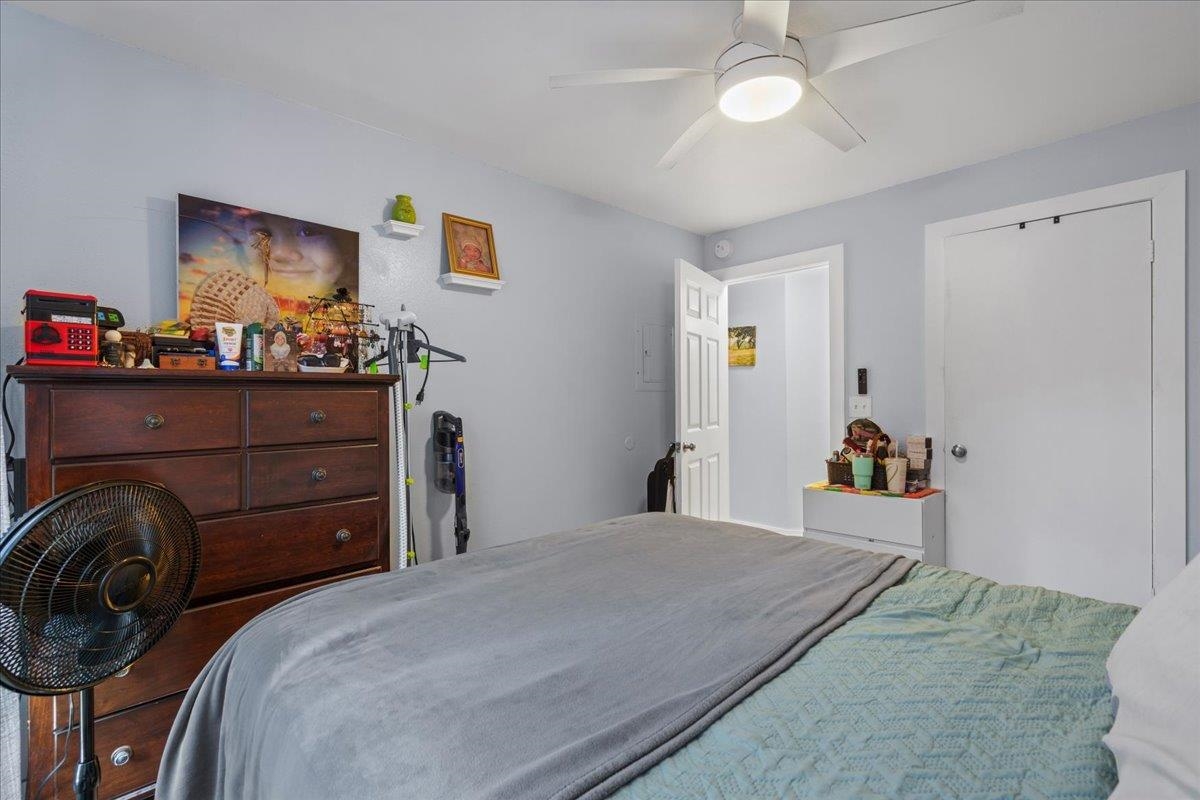480 Kenolio Road, Unit 1103 Kihei, HI 96753 - Photo 22 of 32 a bedroom with a bed and a dresser