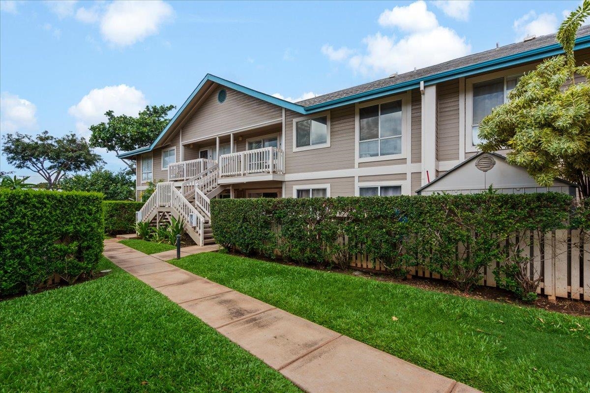 480 Kenolio Road, Unit 1103 Kihei, HI 96753 - Photo 31 of 32 a front view of a house with a yard and potted plants