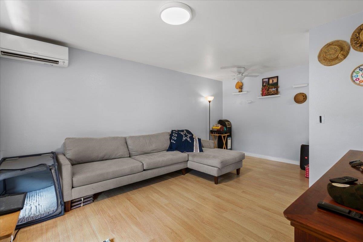 480 Kenolio Road, Unit 1103 Kihei, HI 96753 - Photo 4 of 32 a living room with furniture and a wooden floor