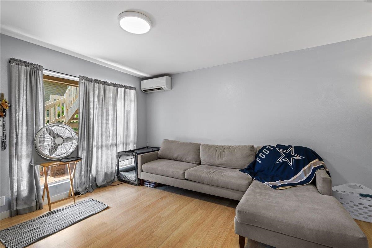480 Kenolio Road, Unit 1103 Kihei, HI 96753 - Photo 5 of 32 a living room with furniture a couch and a window