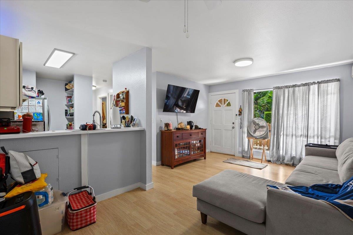 480 Kenolio Road, Unit 1103 Kihei, HI 96753 - Photo 6 of 32 a living room with furniture and a flat screen tv