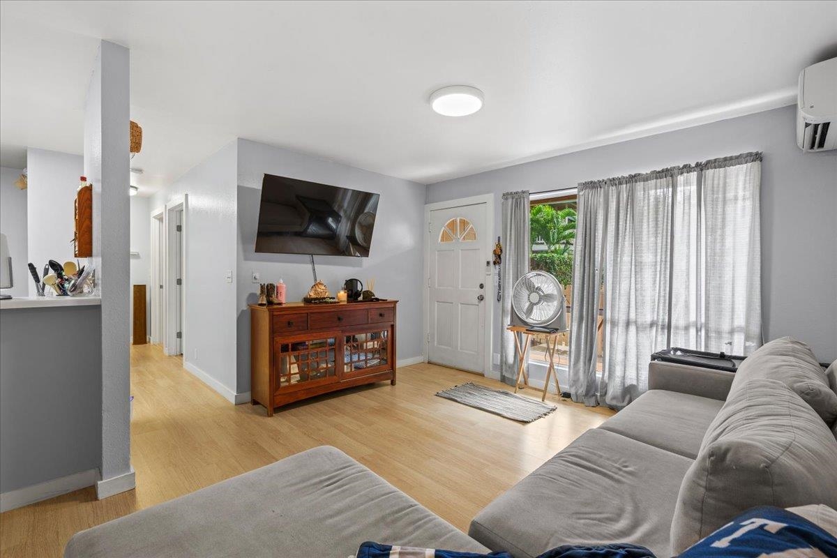 480 Kenolio Road, Unit 1103 Kihei, HI 96753 - Photo 7 of 32 a living room with furniture and a flat screen tv