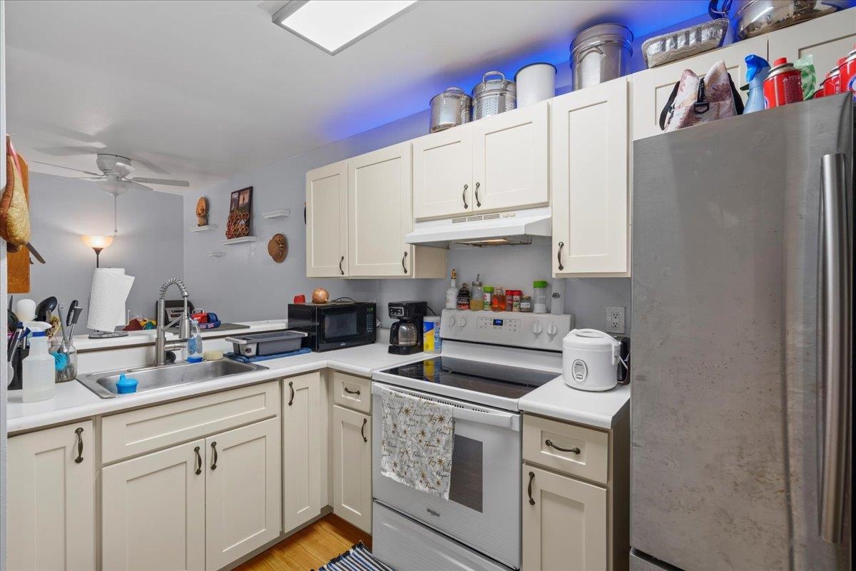 480 Kenolio Road, Unit 1103 Kihei, HI 96753 - Photo 9 of 32 a kitchen with a sink cabinets and appliances