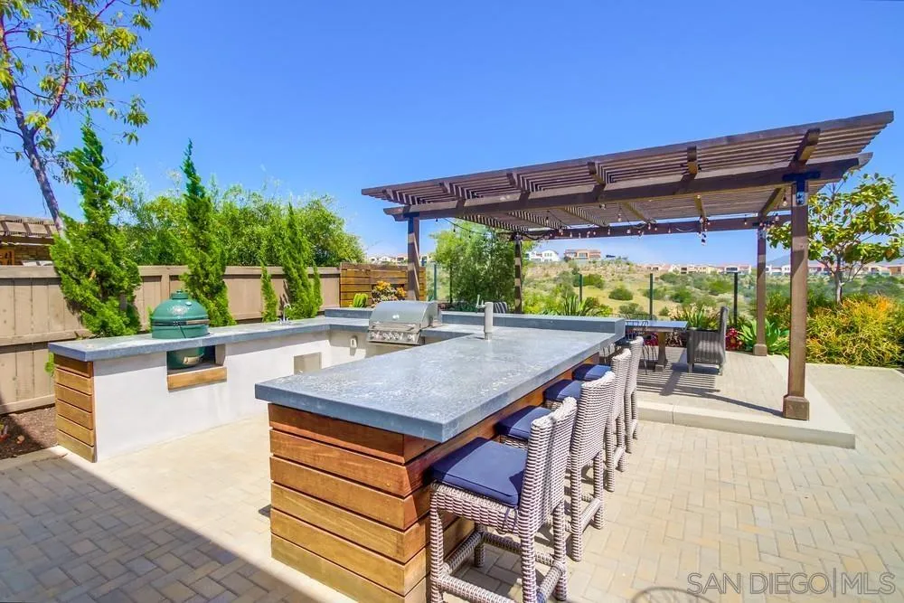 15501 Tanner Ridge Road San Diego, CA 92127 - Photo 14 of 18 a view of a patio with a table and chairs under an umbrella