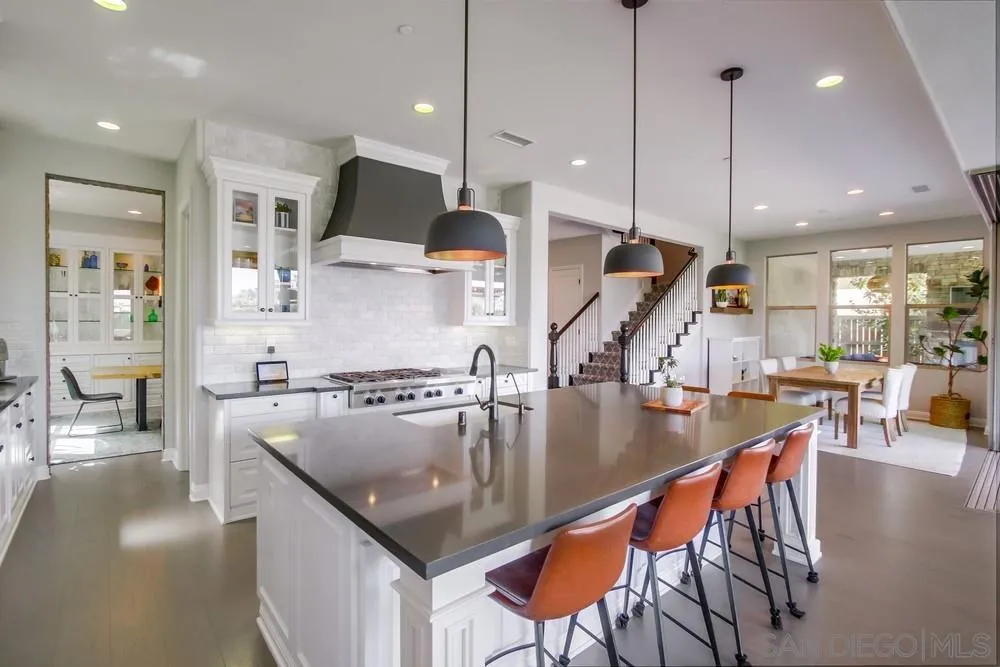 15501 Tanner Ridge Road San Diego, CA 92127 - Photo 5 of 18 a kitchen with stainless steel appliances granite countertop a sink a stove and a wooden floors