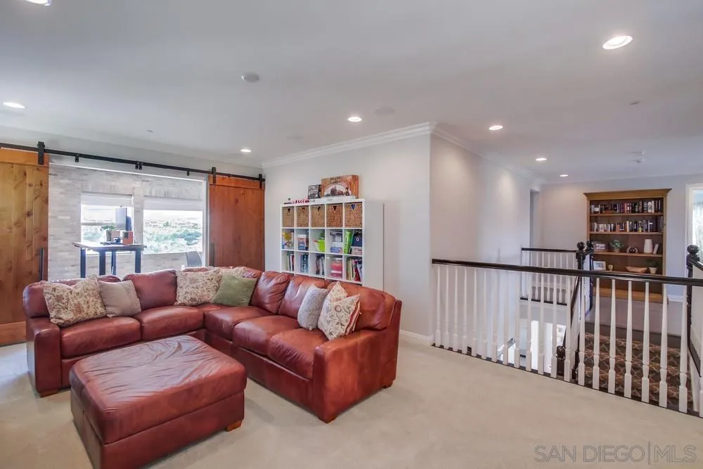 15501 Tanner Ridge Road San Diego, CA 92127 - Photo 8 of 18 a living room with furniture and a book shelf