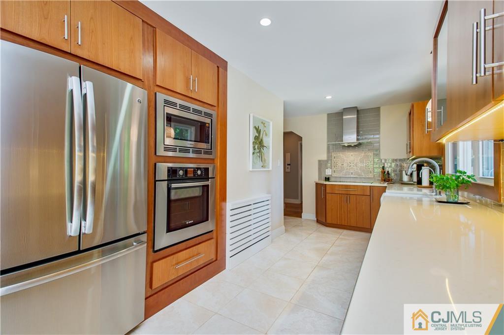 764 Old Raritan Road Edison, NJ 08820 - Photo 7 of 20 a kitchen with stainless steel appliances a refrigerator and a stove top oven