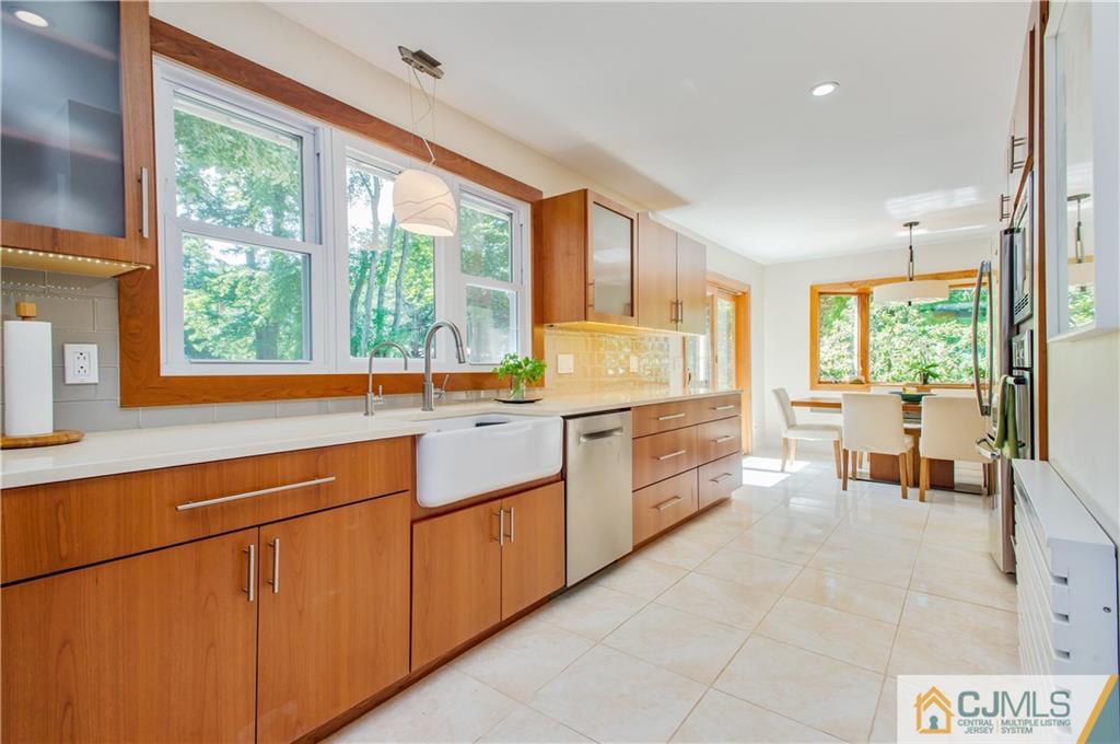 764 Old Raritan Road Edison, NJ 08820 - Photo 8 of 20 a kitchen with sink a stove and chairs