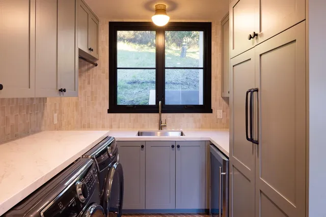 a kitchen with stainless steel appliances a sink and a window