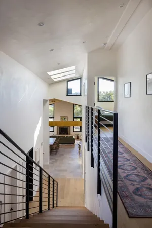 a view of a livingroom with furniture and staircase