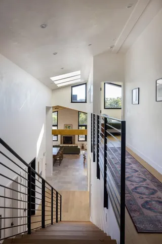 a view of a livingroom with furniture and staircase