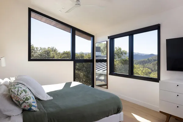 a bedroom with a large bed and a large window