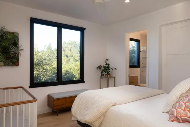 a bedroom with a large bed and a window