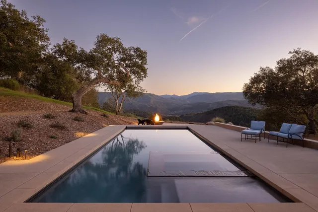 a view of a patio with dining table and chairs