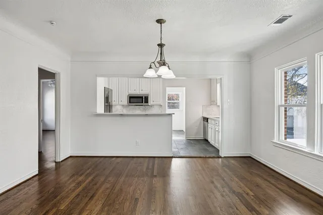 a view of a kitchen with a sink wooden floor and windows
