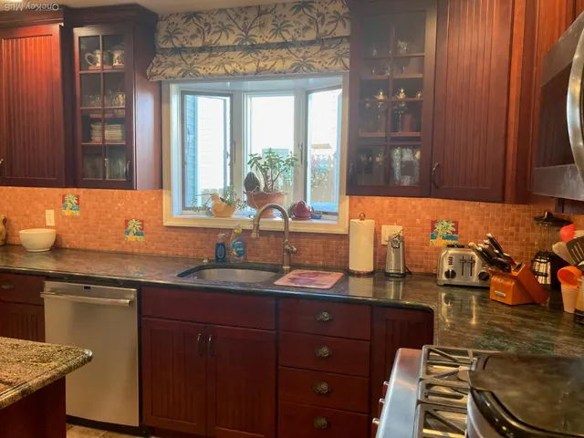 a view of a chairs and tables in the back yard of the house