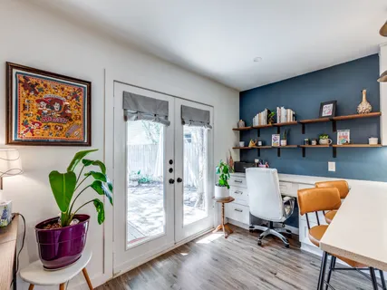 a workspace with furniture and a potted plant