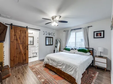 a bedroom with a bed dresser and a window