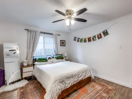 a bedroom with a large bed and a chandelier