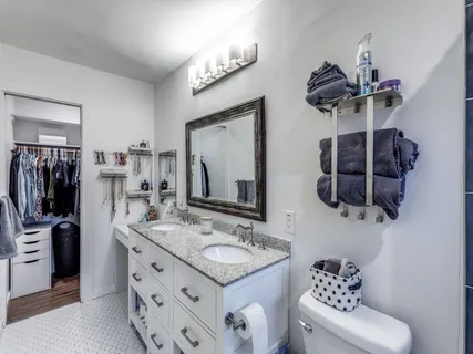 a bathroom with a sink double vanity and a mirror