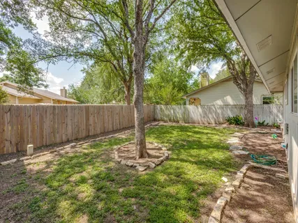 a backyard of a house with table and chairs
