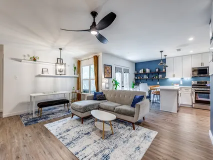 a living room with furniture and kitchen view