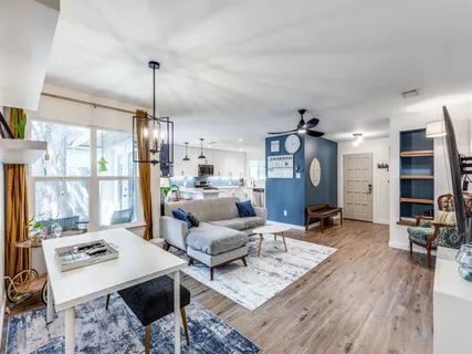 a living room with furniture and wooden floor