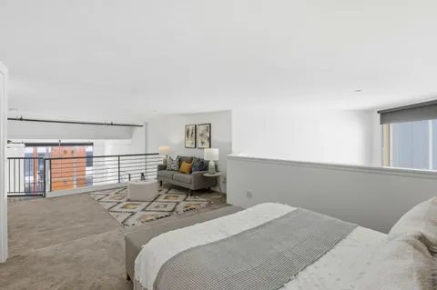 a bedroom with a bed and painting on the wall