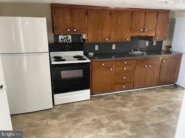 a kitchen with a cabinets and white appliances