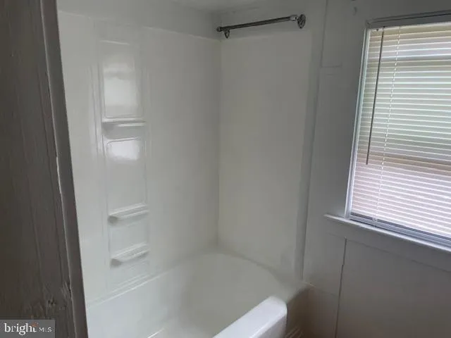 a view of an empty room with windows