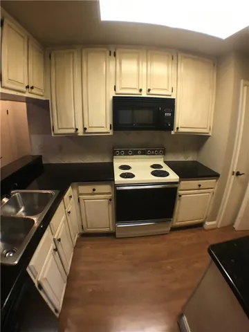 a kitchen with a stove a microwave and sink