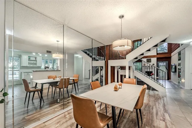 a dining table with chairs and wooden floor