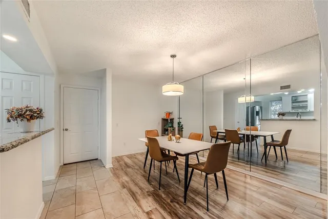 a view of a dining room with furniture and chandelier
