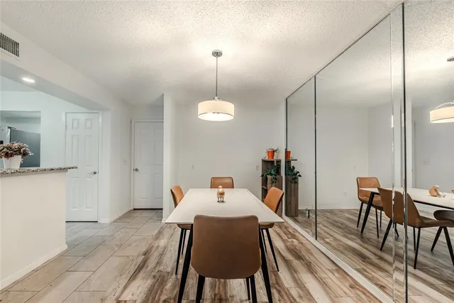 a dining room with furniture and wooden floor