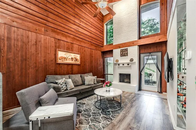 a living room with furniture a fireplace and a window