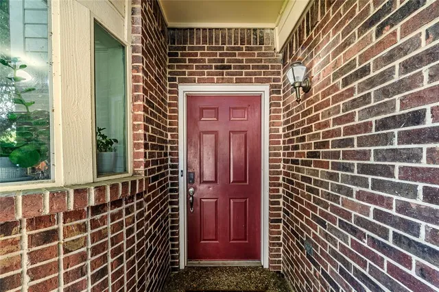 a view of a door with brick walls