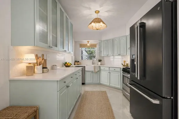 a kitchen with a sink cabinets and window