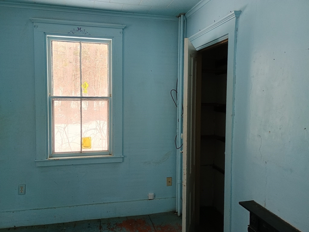 9 Olive Street Ashland, MA 01721 - Photo 12 of 33 a view of an empty room with wooden floor and a window