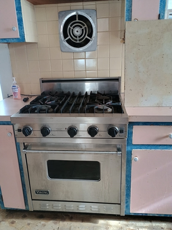 9 Olive Street Ashland, MA 01721 - Photo 26 of 33 a stove top oven sitting inside of a kitchen