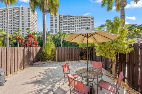 a backyard of a house with table and chairs